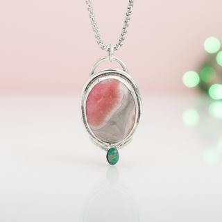 Necklace with a pink stone pendant on a white background