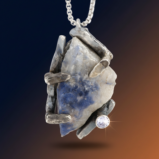 Pendant with blue stone and silver frame on a gradient background