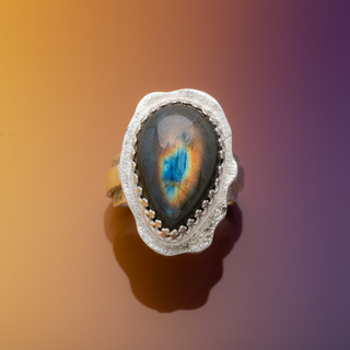 Silver ring with an oval stone on a white background