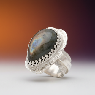 Silver ring with a large gemstone on a white background