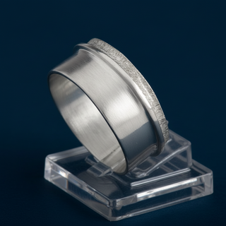 A silver ring with a polished, brushed, and hammered finish